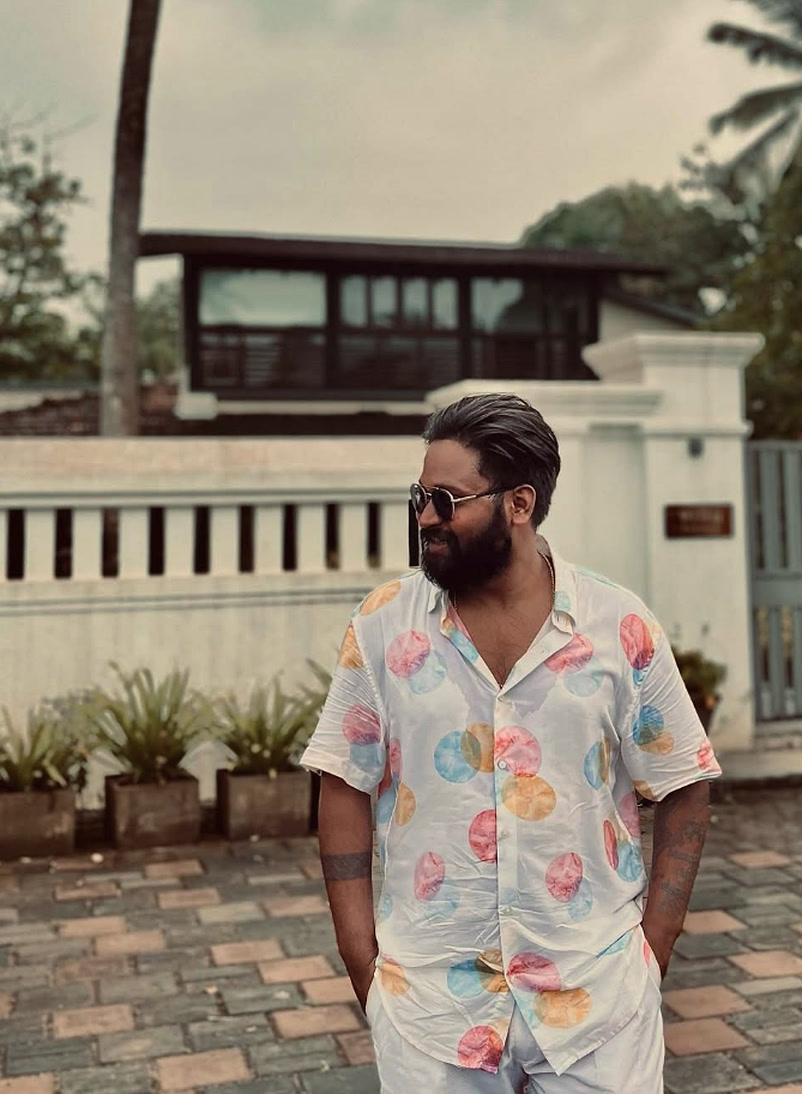 Devansh Singh in stylish resort attire and sunglasses at luxury villa destination — Kamal Productions Devansh Singh
